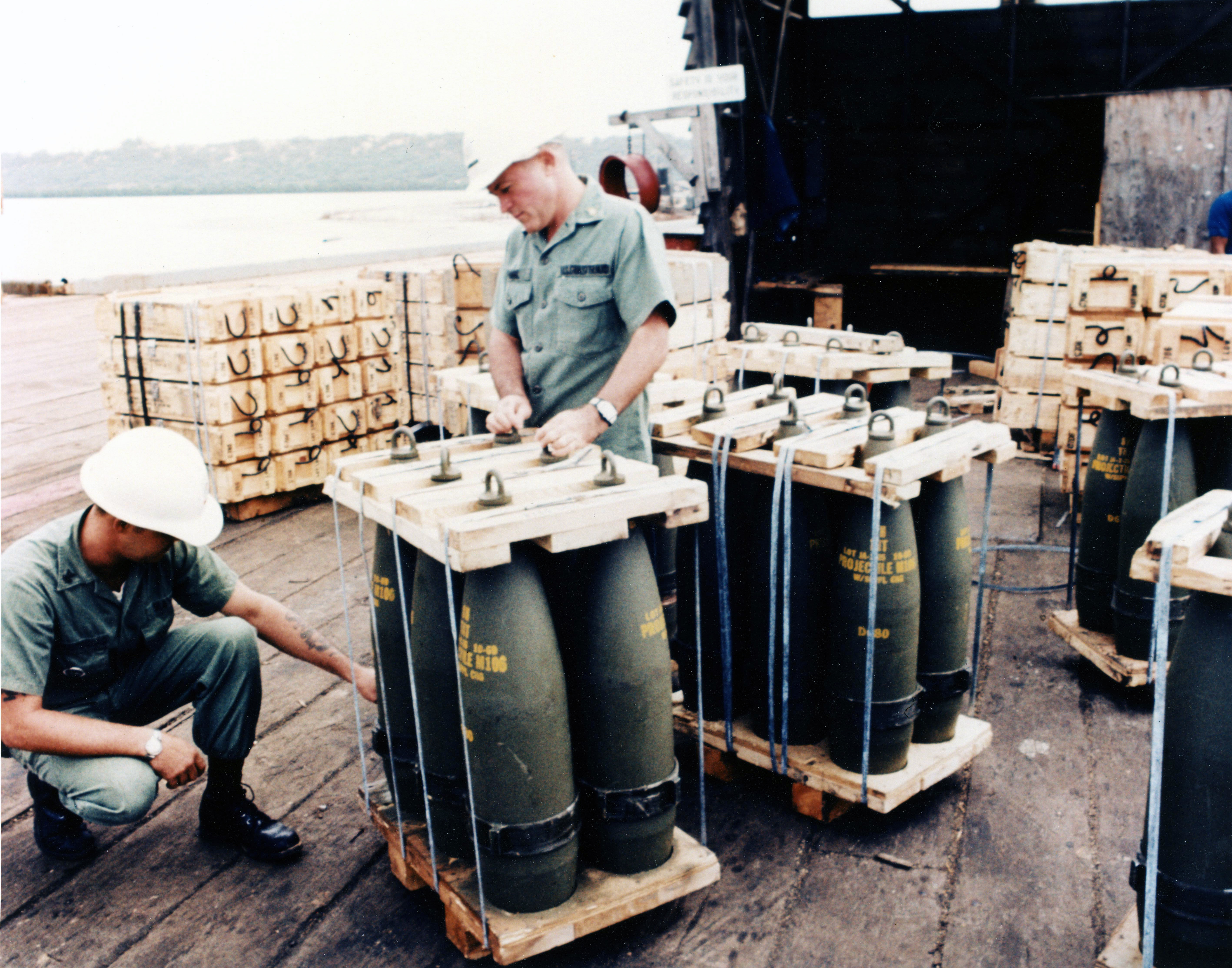 Explosive Loading Detachment personnel prepare a cargo of ordnance for offloading. (U.S. Coast Guard) Explosive Loading Detachment personnel prepare a cargo of ordnance for offloading. (U.S. Coast Guard)